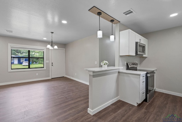 251 Crockett St, Lone Star, TX 75668 - kitchen with stainless steel appliances, a peninsula, dark wood-style flooring, light countertops, and recessed lighting