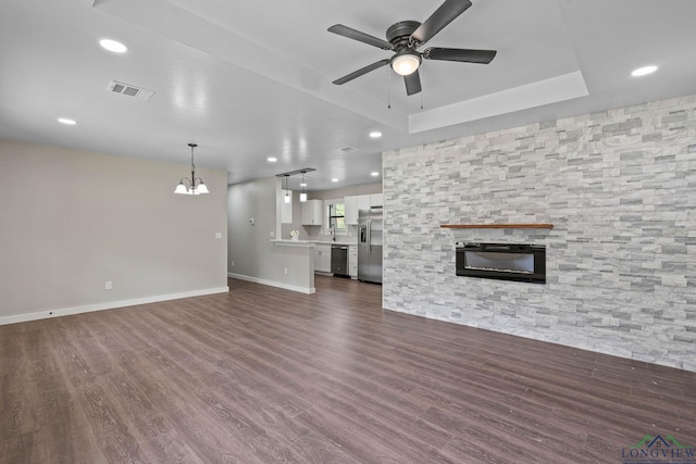 251 Crockett St, Lone Star, TX 75668 - unfurnished living room featuring a chandelier, a ceiling fan, a stone fireplace, recessed lighting, and dark wood-style floors