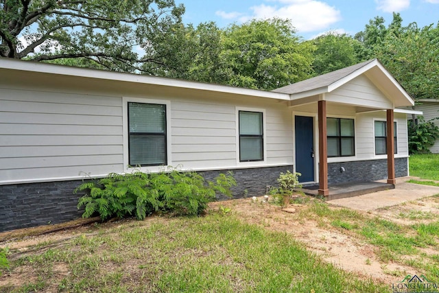 251 Crockett St, Lone Star, TX 75668 - ranch-style house with stone siding and a front yard