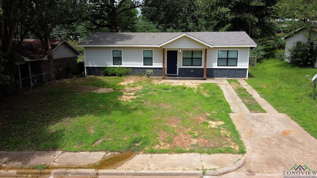 251 Crockett St, Lone Star, TX 75668 - view of front of home featuring stone siding and a front lawn