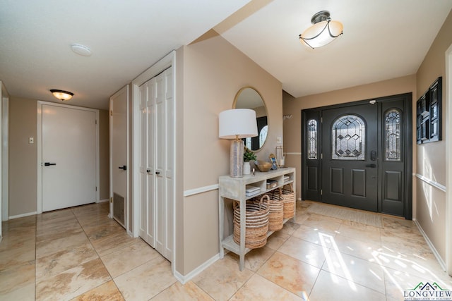 tiled entryway featuring baseboards