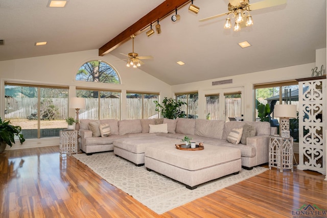 living room featuring wood finished floors, visible vents, high vaulted ceiling, ceiling fan, and beamed ceiling