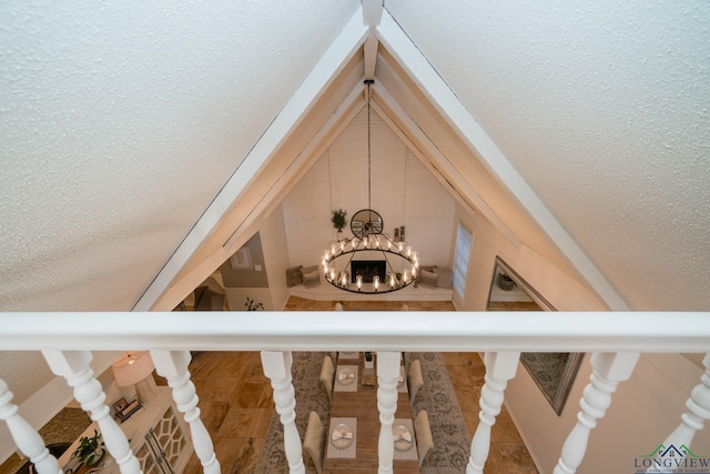 stairway with a notable chandelier