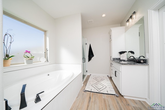 full bath with vanity, wood finished floors, recessed lighting, a stall shower, and a garden tub