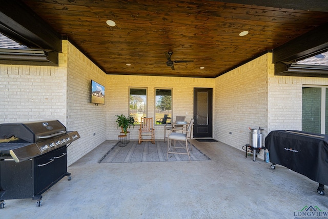 view of patio featuring area for grilling and a ceiling fan