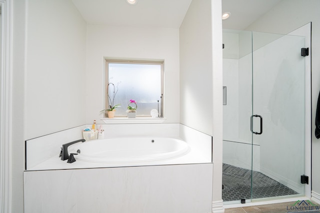 bathroom with a bath, recessed lighting, and a shower stall