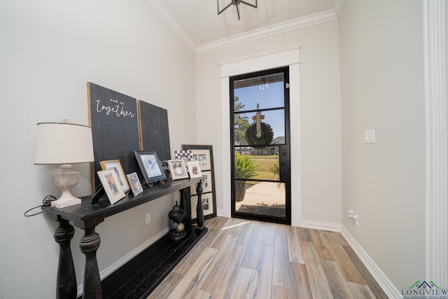 foyer entrance featuring wood finished floors, baseboards, and ornamental molding