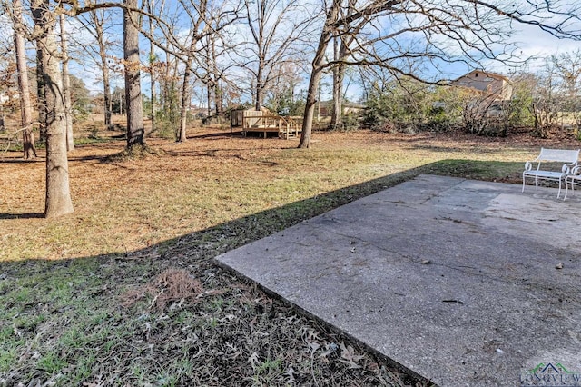 view of yard with a patio and a wooden deck