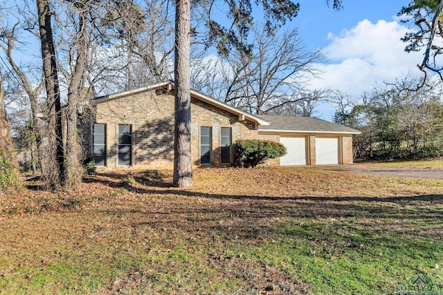 view of home's exterior with a lawn and a garage