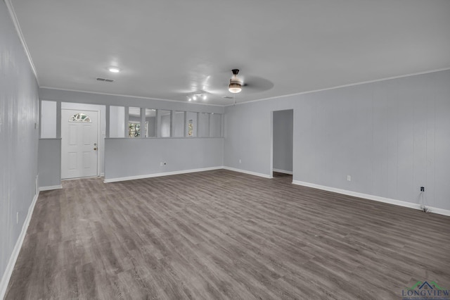 unfurnished living room featuring crown molding, ceiling fan, and dark wood-type flooring