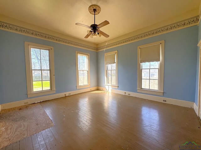 spare room with plenty of natural light, hardwood / wood-style floors, and a ceiling fan