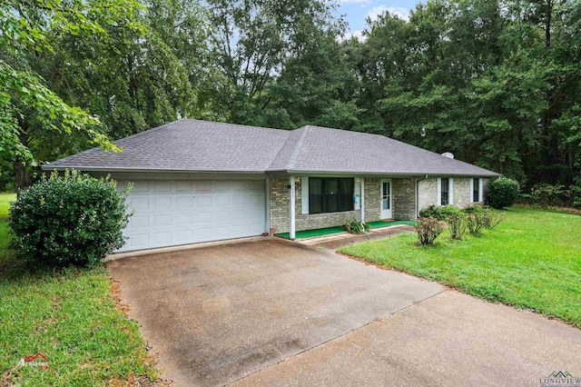 ranch-style house featuring a garage and a front lawn