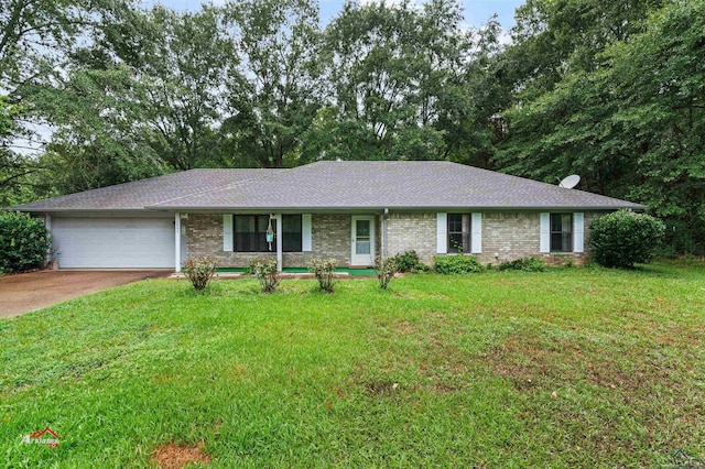 ranch-style home with a garage and a front yard