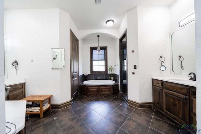 full bath with a garden tub, a shower stall, baseboards, and vanity