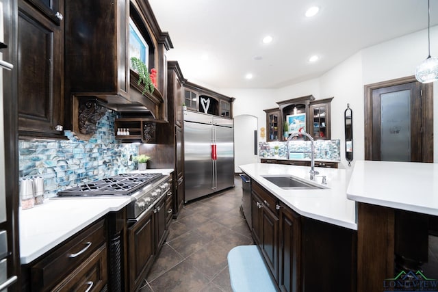 kitchen with stainless steel appliances, a sink, light countertops, tasteful backsplash, and glass insert cabinets