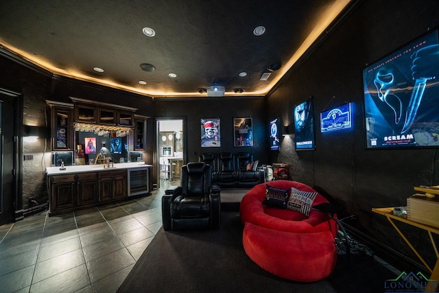 tiled home theater with wine cooler, indoor wet bar, a sink, and recessed lighting