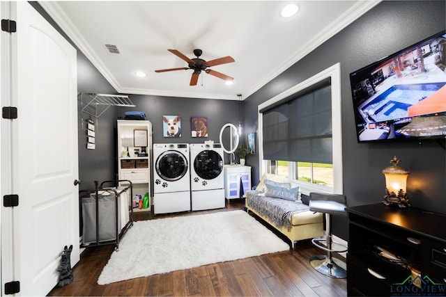 laundry area featuring crown molding, washer and clothes dryer, visible vents, wood finished floors, and laundry area