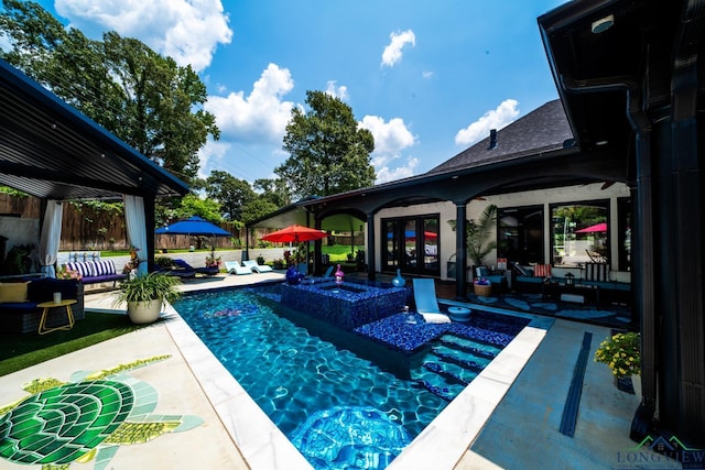 pool with a patio area, fence, and french doors