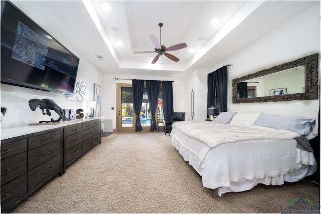 bedroom featuring access to outside, a raised ceiling, light carpet, and recessed lighting