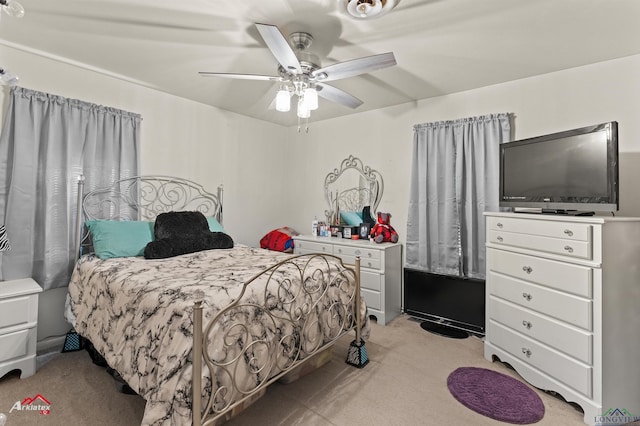 bedroom with light colored carpet and a ceiling fan
