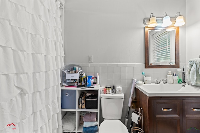bathroom with vanity, toilet, tile walls, and curtained shower