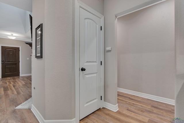 hallway with baseboards and light wood-style flooring