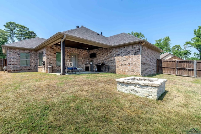 back of property featuring brick siding, fence, roof with shingles, and a patio
