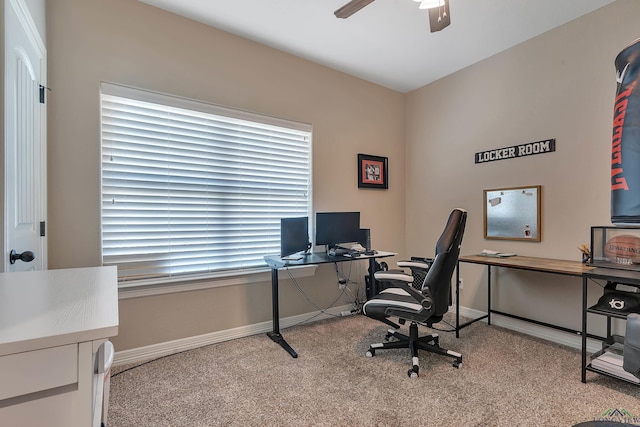 office space featuring a ceiling fan, baseboards, and carpet