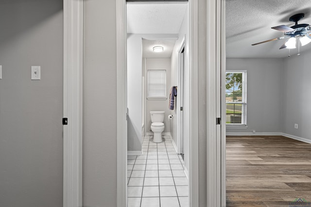 1001 Towne Lake Dr, Longview, TX 75601 - corridor featuring a textured ceiling and tile patterned flooring