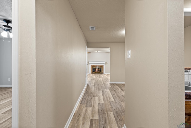 1001 Towne Lake Dr, Longview, TX 75601 - corridor with a textured ceiling and wood finished floors