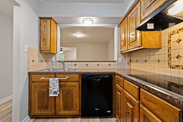 1001 Towne Lake Dr, Longview, TX 75601 - kitchen featuring black appliances, under cabinet range hood, light wood finished floors, brown cabinets, and a textured ceiling