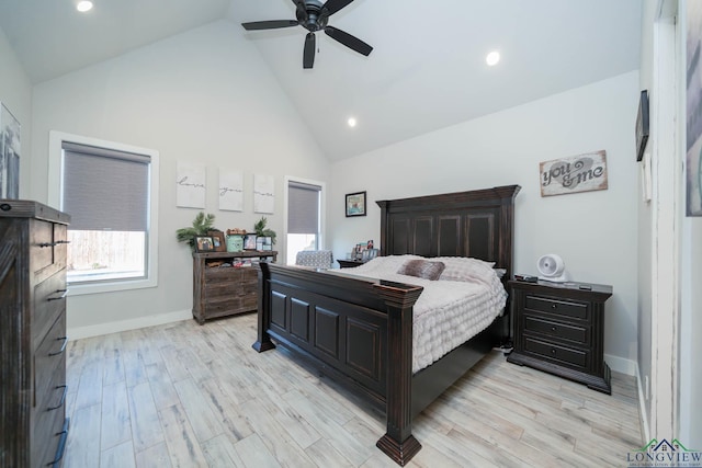 bedroom with light wood-style floors, baseboards, high vaulted ceiling, and a ceiling fan