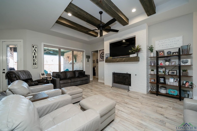 living area featuring recessed lighting, a large fireplace, a ceiling fan, beam ceiling, and light wood finished floors