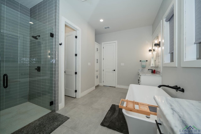 full bath with a stall shower, baseboards, visible vents, tile patterned flooring, and vanity