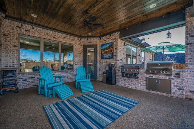 view of patio / terrace with a ceiling fan, an outdoor kitchen, and area for grilling