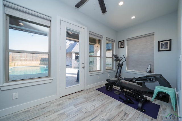 exercise room featuring a ceiling fan, recessed lighting, light wood-style flooring, and baseboards