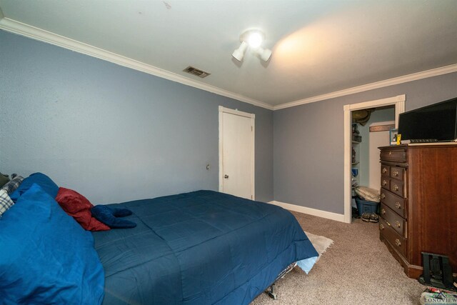 bedroom with crown molding and light colored carpet