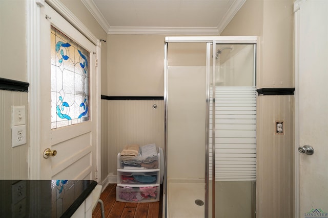 bathroom featuring an enclosed shower, hardwood / wood-style flooring, and ornamental molding