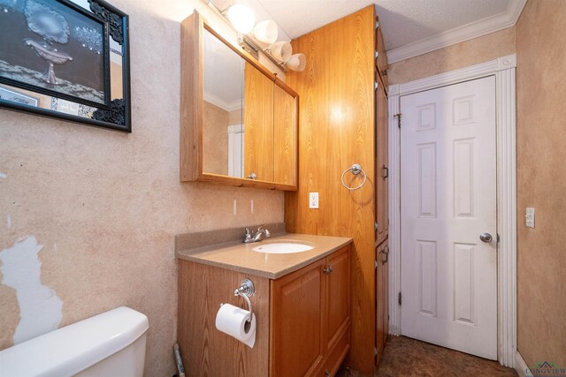 bathroom featuring vanity, ornamental molding, and toilet