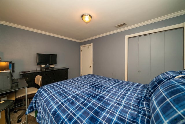 bedroom with ornamental molding, carpet flooring, and a closet