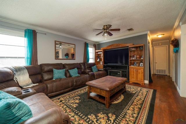 living room with dark hardwood / wood-style flooring, plenty of natural light, ornamental molding, and ceiling fan