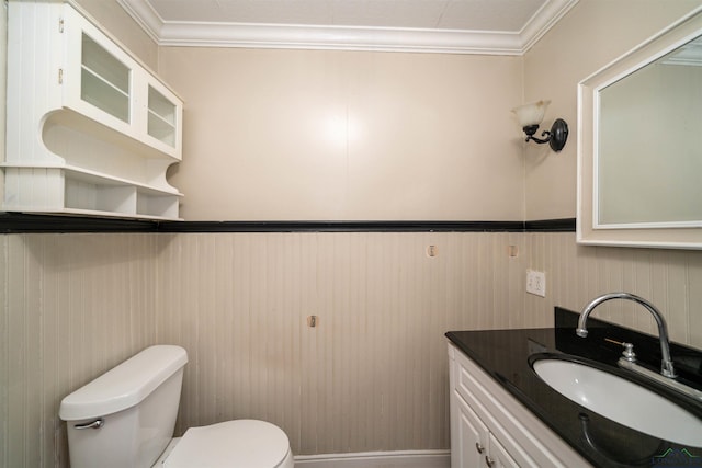 bathroom featuring vanity, ornamental molding, and toilet