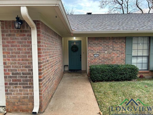 1203 Tiffany Ln, Longview, TX 75604 - view of exterior entry with brick siding and a shingled roof