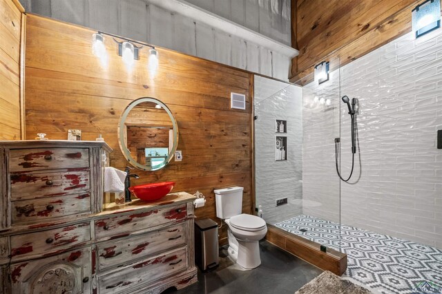 13391 County Road 4336, Larue, TX 75770 - bathroom with a tile shower, vanity, wood walls, and concrete floors
