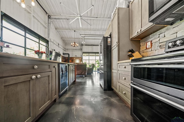 13391 County Road 4336, Larue, TX 75770 - kitchen featuring stainless steel appliances, finished concrete flooring, beverage cooler, and high vaulted ceiling