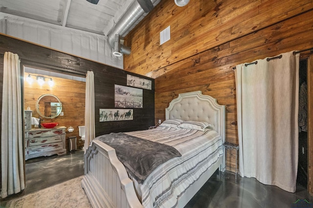 13391 County Road 4336, Larue, TX 75770 - bedroom featuring wooden walls and concrete flooring