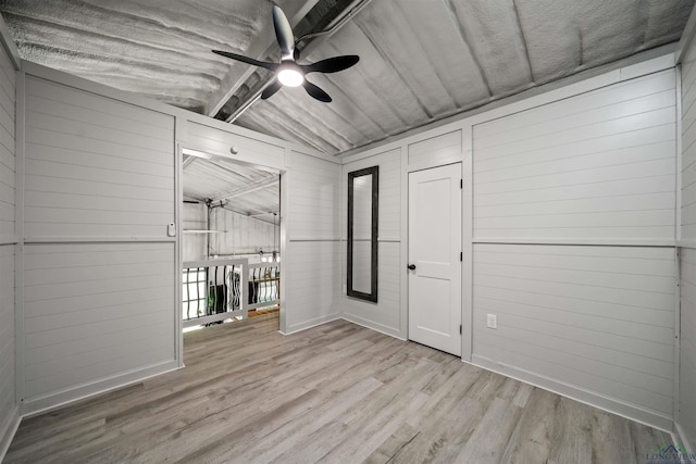 13391 County Road 4336, Larue, TX 75770 - empty room featuring a ceiling fan, wood finished floors, baseboards, and wood walls