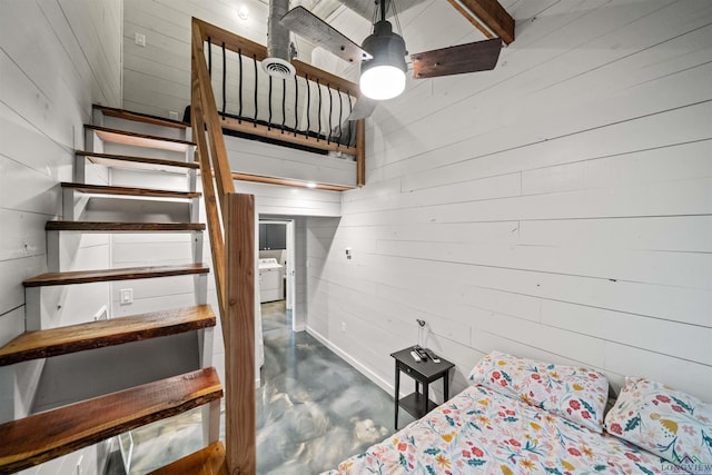 13391 County Road 4336, Larue, TX 75770 - bedroom with concrete floors, wood walls, and washer / clothes dryer