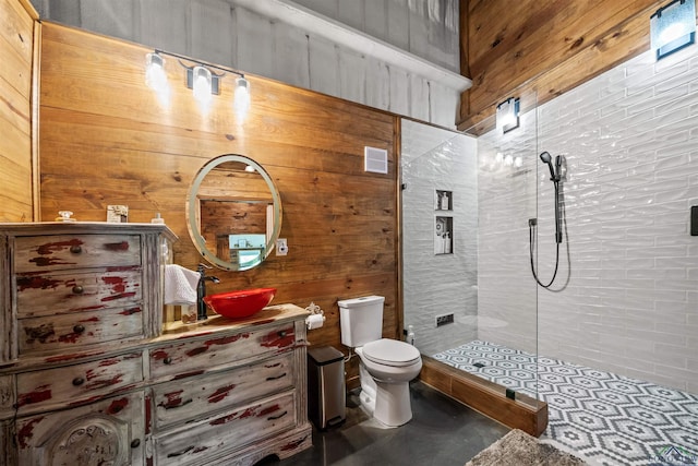 13391 County Road 4336, Larue, TX 75770 - bathroom with toilet, a tile shower, vanity, wood walls, and concrete floors