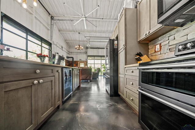 13391 County Road 4336, Larue, TX 75770 - kitchen featuring stainless steel appliances, wine cooler, concrete flooring, and lofted ceiling